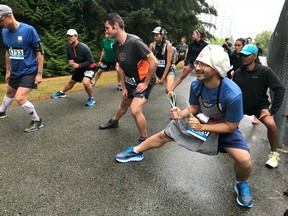 Justin Bailey, dressed up as The Chef for MEC Vancouver's Trail Race Series event in Burnaby on Sunday morning, warms up before the 10K race in Central Park. More than 280 runners competed in the 10K and 5K races that started and finished at Swangard Stadium.