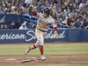 Mookie Betts of the Boston Red Sox, celebrating after a ninth-inning home run against the Toronto Blue Jays on Thursday, Aug. 9, is one of the many upbeat stories for the red-hot MLB squad these days.