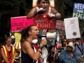 Tawahum Bige from the Lutsel k'e Dene and Plains Cree nation shouts words of support for protesters gathered outside the Vancouver Island Conference Centre during day two of the Liberal cabinet retreat in Nanaimo, B.C., on Wednesday, August 22, 2018.