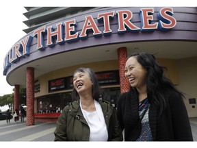 In this Thursday, Aug. 23, 2018 photo, Alice Sue, left, and her daughter Audrey Sue-Matsumoto laugh while interviewed after watching the movie Crazy Rich Asians in Daly City, Calif. It was Sue's second time watching the movie. When "Crazy Rich Asians" surpassed expectations and grabbed the top spot in its opening weekend, the film also pulled off another surprising feat. It put Asians of a certain age in theater seats.