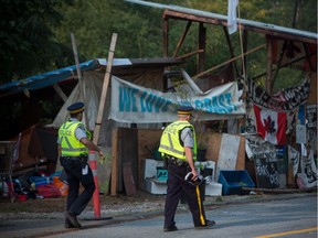 Burnaby RCMP and city of Burnaby officials dismantle Camp Cloud near the entrance of the Kinder Morgan Trans Mountain pipeline facility in Burnaby, B.C., on Thursday August 16, 2018.