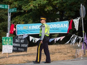 Burnaby RCMP and City of Burnaby officials dismantle Camp Cloud near the entrance of the Kinder Morgan Trans Mountain pipeline facility on August 16, 2018.