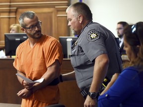 Christopher Watts glances back at a Weld County Sheriff's Deputy as he is escorted out of the courtroom at the Weld County Courthouse Thursday, Aug. 16, 2018, in Greeley, Colo.