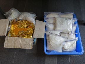 Police show some of the 35 kg in heroin seized at Vancouver International Airport in June 2014. Tenny Guon Lim, 34, is the second man to plead guilty to possession for the purpose of trafficking in connection with the seizure.