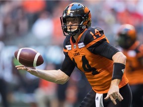 B.C. Lions quarterback Travis Lulay tosses the ball to teammate Emmanuel Arceneaux during CFL action against the Edmonton Eskimos in Vancouver on Aug. 9.