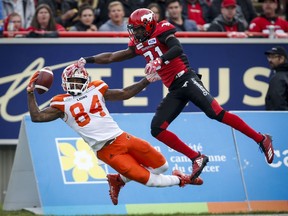 BC Lions' Emmanuel Arceneaux, left, can't hang onto the ball as Calgary Stampeders' Tre Roberson, covers him during first quarter CFL football action in Calgary, Saturday, Aug. 4, 2018.