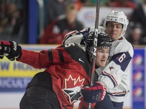 Team Canada's Michael Rasmussen of Surrey checks Team USA Jack Drury during Tuesday's World Junior Showcase action at the Sandman Centre in Kamloops. Rasmussen, a centre playing wing in the tournament, is expected to play for the Detroit Red Wings this season.