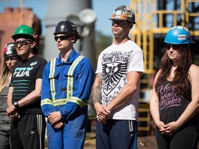 Apprentice ironworkers listen as B.C. Premier John Horgan speaks during an announcement at the Ironworkers Training Facility at the British Columbia Institute of Technology, in Burnaby, B.C., on Monday July 16, 2018.