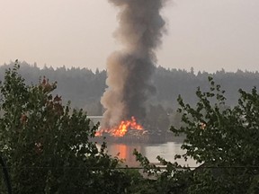 Crews are battling a barge fire in Surrey.