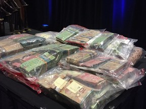 Bags of cash, part of the items seized by police and displayed at a news conference on Friday. (Photo: Kim Bolan)