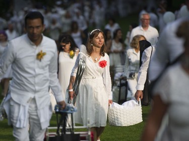 People arrive for the 7th Annual Le Dîner en Blanc  at the VanDusen Botanical Garden in Vancouver on Thursday.