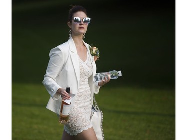 People arrive for the 7th Annual Le Dîner en Blanc  at the VanDusen Botanical Garden in Vancouver on Thursday.