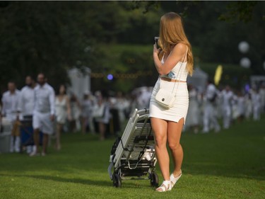 People arrive for the 7th Annual Le Dîner en Blanc  at the VanDusen Botanical Garden in Vancouver on Thursday.