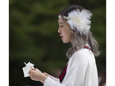 Isabelle Zhang sets out silverware for her 7th Annual Le Dîner en Blanc  at the VanDusen Botanical Garden in Vancouver on Thursday.