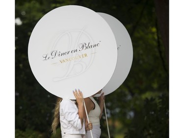 Signs for the 7th Annual Le Dîner en Blanc at the VanDusen Botanical Garden in Vancouver on Thursday.