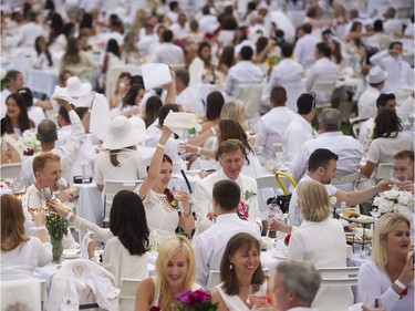 A toast and the waving of napkins officially starts the 7th Annual Le Dîner en Blanc at the VanDusen Botanical Garden in Vancouver on Thursday.