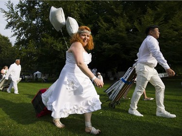 People arrive for the 7th Annual Le Dîner en Blanc  at the VanDusen Botanical Garden in Vancouver on Thursday.