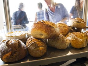 A customer looks over fresh baked bread at Bigsby The Bakehouse,  Vancouver, August 11 2018.
