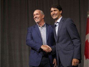 Canadian Prime Minister Justin Trudeau meets with B.C. Premier John Horgan at the Vancouver Island Conference Centre during the Liberal cabinet retreat in Nanaimo on Tuesday, Aug. 21.