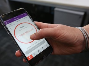 A women demonstrates using the Natural Cycles smartphone app, in London, Friday, Aug. 17, 2018. The mobile fertility app, has become the first ever digital contraceptive device to win FDA (US Food and Drug Administration) marketing approval, enabling women to track their menstrual cycle and uses an algorithm to determine when they're fertile, and need to use birth control protection.