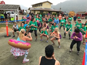 Shelley Hatfield of Aldergrove, in her colourful outfit, leads the Saturday morning pre-race warmup at the Chilliwack Fair. More than 100 runners took part in the 146-year-old fair's inaugural 8K and 4K Donut Dash.