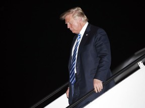 President Donald Trump steps off Air Force One as he arrives Tuesday, Aug. 21, 2018, at Andrews Air Force Base, Md.