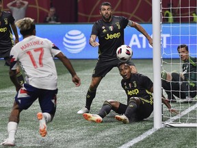 MLS All-Star forward Josef Martinez (17) goes for the ball against Juventus goalkeeper Wojciech Szczesny, right, during the MLS All-Star soccer match, Wednesday, Aug. 1, 2018, in Atlanta.