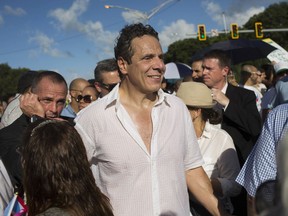 FILE - In this Nov. 5, 2015, file photo, New York Gov. Andrew Cuomo marches during a protest in San Juan, Puerto Rico.