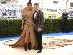 FILE - In this May 1, 2017 file photo, Priyanka Chopra, left, and Nick Jonas attend The Metropolitan Museum of Art's Costume Institute benefit gala celebrating the opening of the Rei Kawakubo/Comme des Garçons: Art of the In-Between exhibition in New York. The couple announced on their respective Instagram accounts that they are engaged, Saturday, Aug. 18, 2018. Each posted the same picture, a close-up of them gazing lovingly at each other, an engagement ring on Chopra's finger.