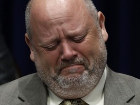 Former priest James Faluszczak, who says he was molested by a priest as a teenager, reacts as Pennsylvania Attorney General Josh Shapiro speaks during a news conference at the Pennsylvania Capitol in Harrisburg, Pa., Tuesday, Aug. 14, 2018.