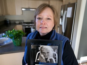 Judy Peterson, holds a picture of her daughter, Lindsey Nicholls in Victoria, February  12, 2014. Lindsey Nicholls went missing from near Courtenay in 1993. Federal govt committed in budget to create national DNA data bank that Peterson has been lobbying for.