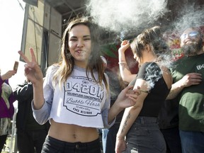 FILE PHOTO: A young woman at the annual "420 celebration" and smoke up in front of  Sunset beach in Vancouver on  April 20, 2017.