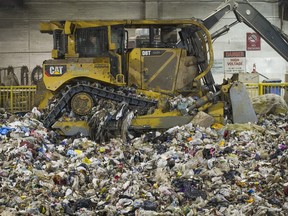 A front-end loader moves garbage inside the pit at the Kent Avenue Transfer Station in Vancouver.