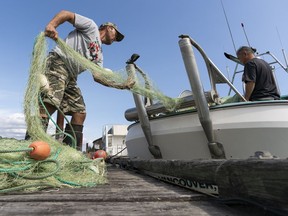 Richmond fishermen Roy Jantunen (left) and Doug Suto get their gear ready for the opening of the Sockeye Salmon fishery on the Fraser River in Richmond, BC, August, 3, 2018.