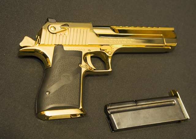 A gold-plated gun, part of the items seized by police and displayed at a news conference on Friday in Vancouver. (Photo: Francis Georgian, PNG)