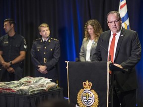 Brian Gateley, Combined Forces Special Enforcement Unit of B.C. superintendent, at the podium with some other members of the combined police task force, talks about the arrests and seizure of weapons, drugs, explosive devices and other property on Friday.