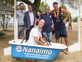 Jamie Pitblado of the Pitblado Group hams it up in a bathtub, while (from left) park board commissioners Michael Wiebe, John Coupar and Erin Shum look on along with Greg Peacock of the Loyal Nanaimo Bathtub Society and Howard Kelsey of Kitsfest.