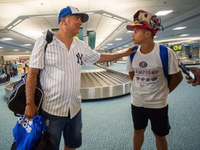 Dio Gama and his dad Noe arrive at Vancouver International airport in Richmond on Sunday. The 13-year-old, whose team just won their way into the Little League World Series, is headed home instead of Williamsport because his immigration status has not yet been sorted.