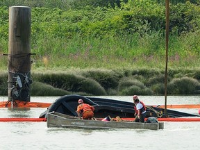 Salvage crews try to raise a sunken tugboat, operated by Ledcor Group, in the north arm of the Fraser River in Vancouver on Wednesday, Aug. 15, 2018.