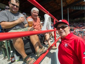 Doug McRae (centre) with son Carlon (left) in the stands at Scotiabank Field at Nat Bailey Stadium talking to C's staff Hans Havas (right) during a recent nooner.