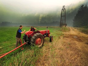 Henry Gouwenberg, right, is under an evacuation alert at his farm on Kamp Road due to the Mount Hicks blaze 10 kilometres east of the District of Kent in Agassiz on Aug. 21.