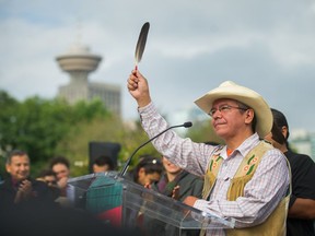 Lee Spahan, chief of the Coldwater Indian Band, raises an eagle feather in celebration in Vancouver on Thursday, after the Federal Court of Appeal’s decision to quash approval of the Trans Mountain oil pipeline expansion.
