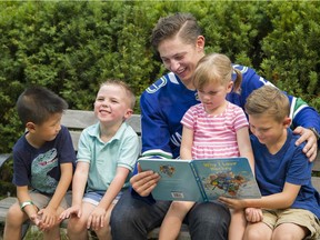 Troy Stecher reads to the ( L - R ) Grayson, Bennett, Avyn and Owen at the PNE , Vancouver, August 22 2018.