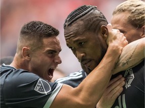 Whitecaps' Jake Nerwinski, left, and Kendall Waston celebrate Waston's second goal against the New York Red Bulls on Saturday.