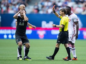 Referee David Gantar issues a red card to a shocked Felipe Martins of the Whitecaps during the first half of Wednesday's Canadian Championship Soccer final between Toronto FC and Vancouver at B.C. Place Stadium. The second leg of the final will be played in Toronto on Wednesday, Aug. 15.