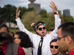 Cedar George-Parker raises his arms and cheers before First Nations leaders respond to a Federal Court of Appeal ruling on the Kinder Morgan Trans Mountain Pipeline expansion, during a news conference in Vancouver, on Thursday, Aug. 30, 2018.