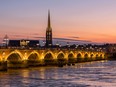 The Pont de Pierre arches across the Garonne River in Bordeaux, France.