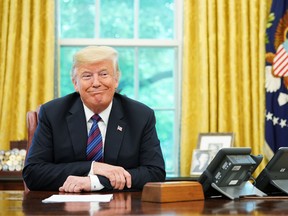 President Donald Trump listens during a phone conversation with Mexico's President Enrique Pena Nieto on trade in the Oval Office of the White House in Washington, D.C. on August 27, 2018. Trump said Monday the U.S. had reached a "really good deal" with Mexico and talks with Canada would begin shortly on a new regional free trade pact."