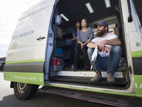 UGM's mobile mission volunteers Deanna Lai and Jessica On sit with UGM's Nathan McLean during a stop in a parking lot in downtown, Langley, August 30 2018.