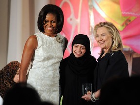 FILE PHOTO: U.S. First Lady Michelle Obama (L) and Secretary of State Hillary Clinton pose with Samar Badawi of Saudi Arabia as she receives the 2012 International Women of Courage Award during a ceremony at the US State Department in Washington, DC, on March 8, 2012. Badawi is currently in jail in Saudi Arabia and at the centre of a storm between Canada and Saudi Arabia.
